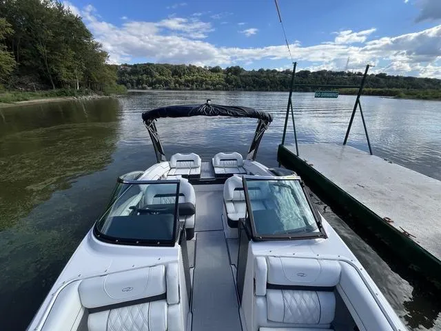 Slide: The Image of 2025 Regal LS4 boat docked on a serene lake with lush greenery. - 15