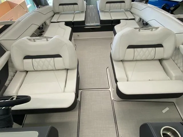 Slide: The Image of 2025 Regal LS4 boat interior with luxurious white seating and modern design. - 21