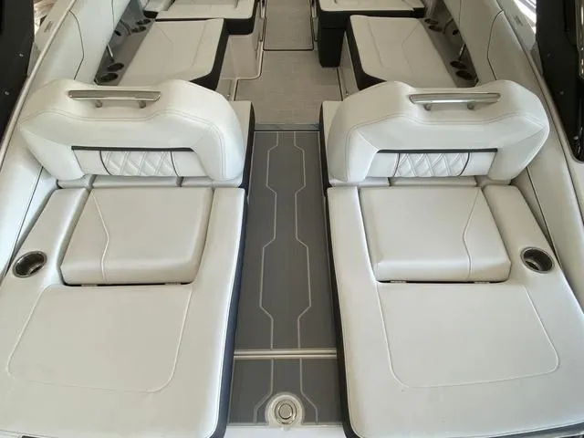 Slide: The Image of 2025 Regal LS4 boat interior with luxurious white seating and modern design. - 24