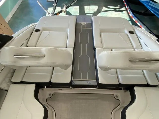 Slide: The Image of 2025 Regal LS4 boat interior with sleek white seating and modern design. - 25