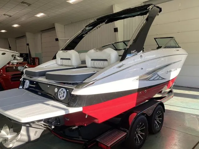 Slide: The Image of 2025 Regal LS4 boat in showroom, red and white design, on trailer. - 31