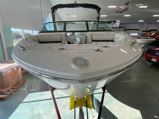 Slide: The Image of 2025 Regal LS4 boat in showroom, front view, sleek white design. - 7