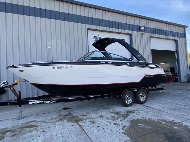 Slide: The Image of 2017 Monterey 278SS boat on trailer outside a warehouse. - 1