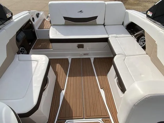Slide: The Image of 2017 Monterey 278SS boat interior with white seating and wood-style flooring. - 11