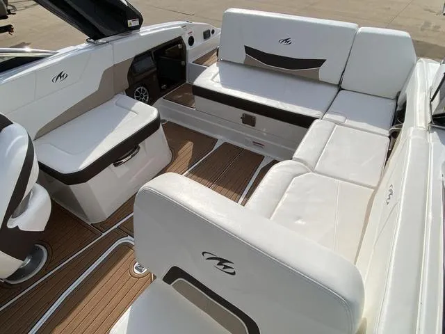 Slide: The Image of 2017 Monterey 278SS boat interior with white seating and wood flooring. - 13