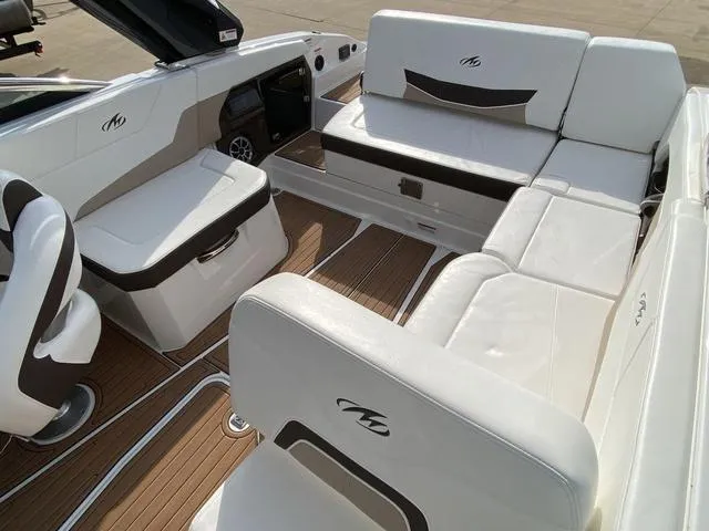 Slide: The Image of 2017 Monterey 278SS boat interior with white leather seating and wood flooring. - 14