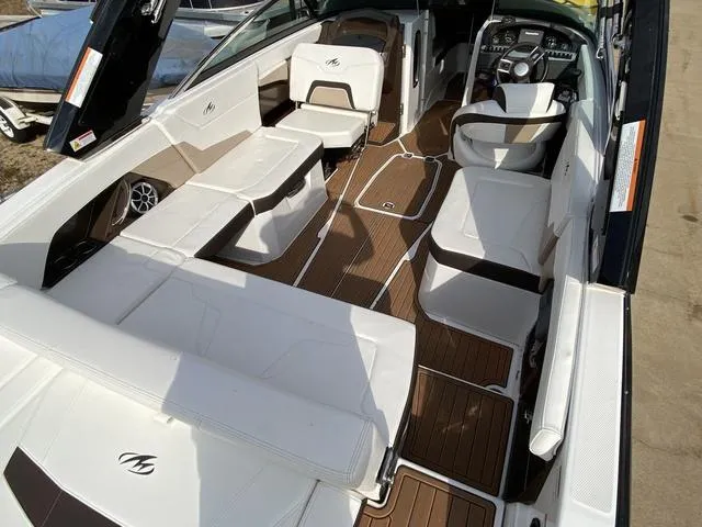 Slide: The Image of 2017 Monterey 278SS boat interior with white seating and wood flooring. - 15