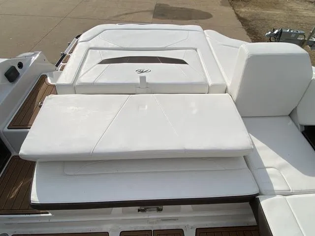 Slide: The Image of 2017 Monterey 278SS boat with white cushioned seating and deck. - 18