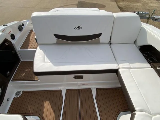 Slide: The Image of 2017 Monterey 278SS boat interior with white seating and wood flooring. - 19