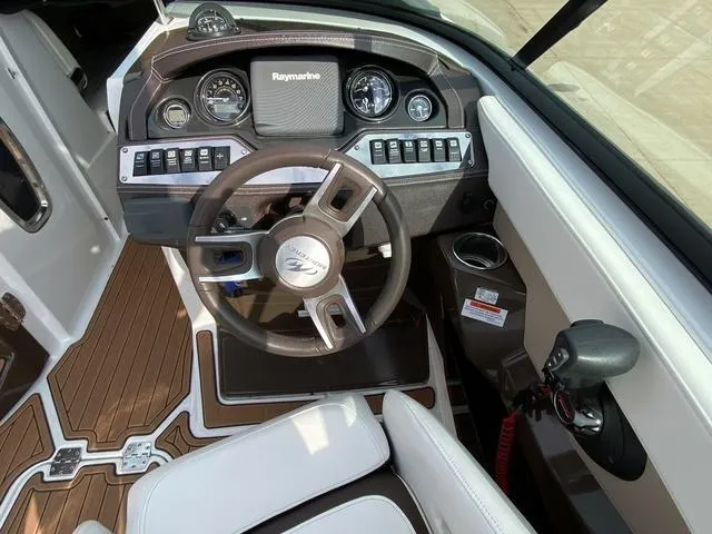 Slide: The Image of 2017 Monterey 278SS boat cockpit with steering wheel and Raymarine navigation system. - 20