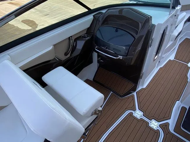 Slide: The Image of 2017 Monterey 278SS boat interior with sleek dashboard and wood-style flooring. - 23