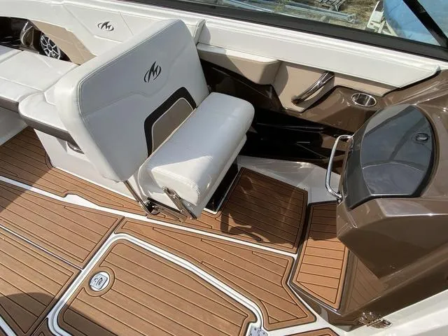 Slide: The Image of 2017 Monterey 278SS boat interior with white seating and teak-style flooring. - 24