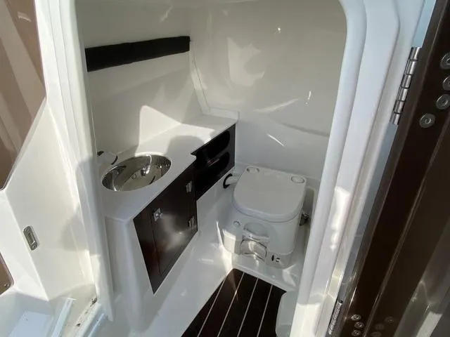 Slide: The Image of 2017 Monterey 278SS boat interior with compact bathroom and sink. - 26