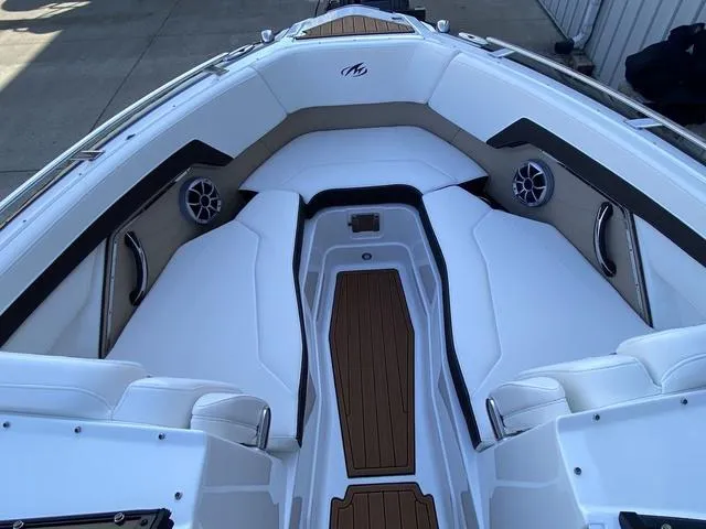 Slide: The Image of 2017 Monterey 278SS boat interior with white seating and wood accents. - 28