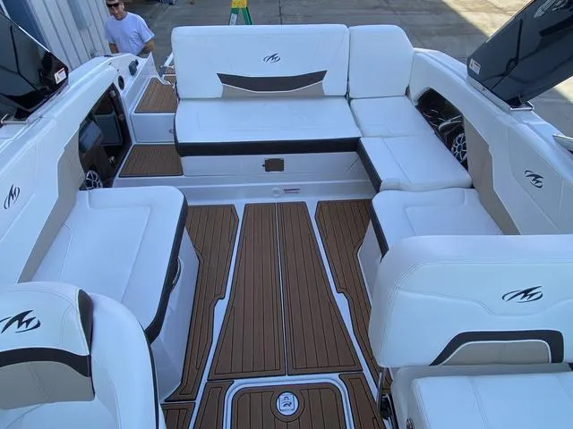 Slide: The Image of 2017 Monterey 278SS boat interior with white seating and wood-style flooring. - 29