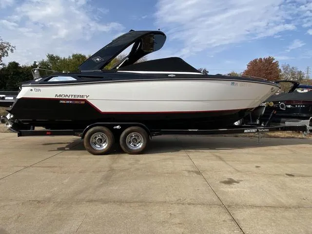 Slide: The Image of 2017 Monterey 278SS boat on trailer, sleek design, black and white exterior. - 3