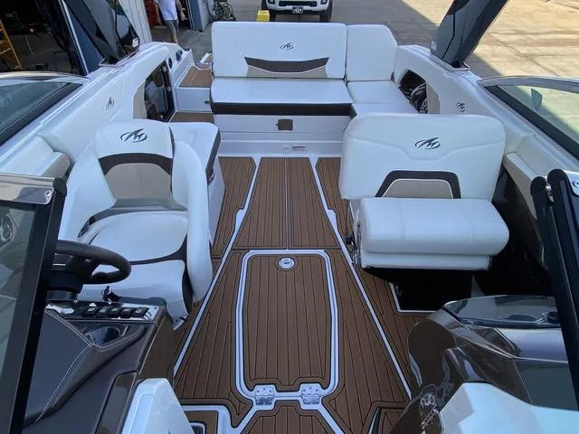 Slide: The Image of 2017 Monterey 278SS boat interior with white seating and wood-style flooring. - 30