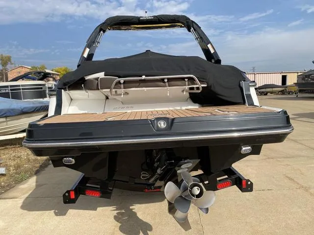 Slide: The Image of 2017 Monterey 278SS boat with covered seating and visible propeller, parked on concrete. - 5