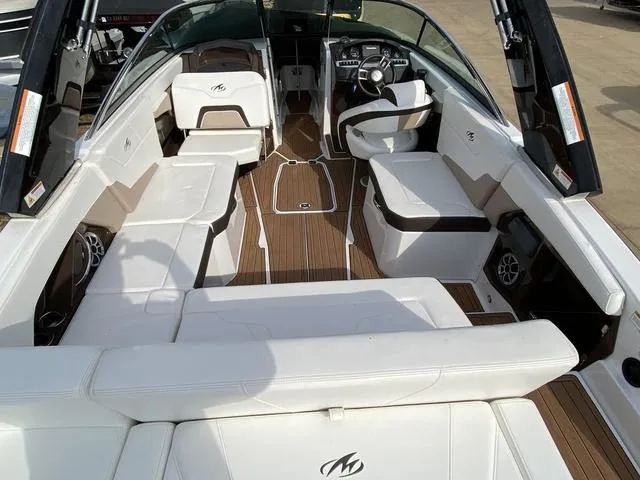 Slide: The Image of 2017 Monterey 278SS boat interior with white seating and wood flooring. - 8