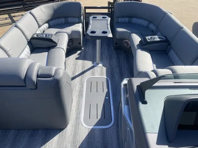 Slide: The Image of 2025 Bennington 25 QFBA pontoon boat interior with gray seating and table. - 10