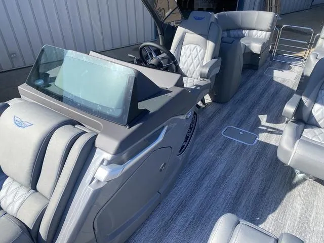 Slide: The Image of 2025 Bennington 25 QFBA boat interior with luxurious seating and modern dashboard. - 14