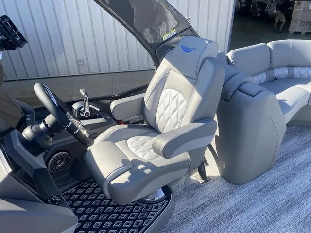 Slide: The Image of 2025 Bennington 25 QFBA boat interior with luxurious seating and modern steering console. - 15