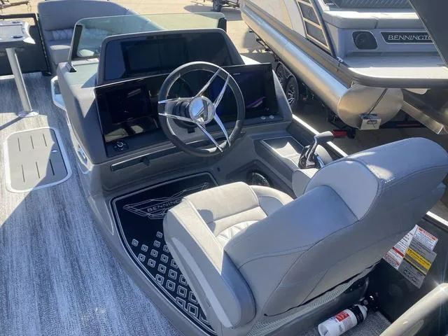 Slide: The Image of 2025 Bennington 25 QFBA boat interior with modern steering console and seating. - 16