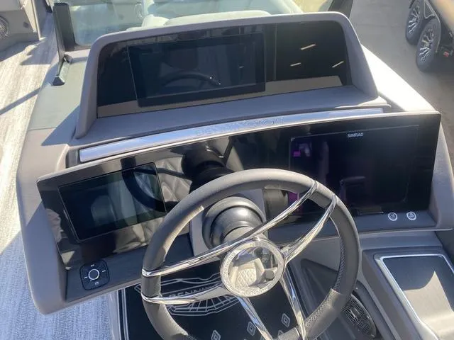 Slide: The Image of Dashboard of 2025 Bennington 25 QFBA boat with modern steering and digital displays. - 18