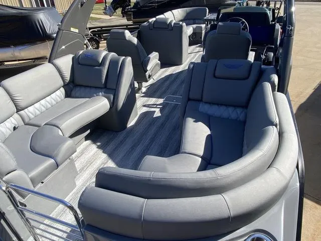 Slide: The Image of 2025 Bennington 25 QFBA pontoon boat with luxurious gray seating and spacious interior. - 23