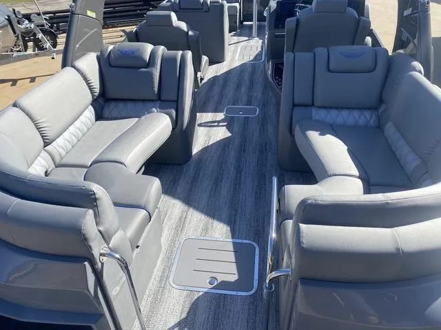 Slide: The Image of Luxurious seating on 2025 Bennington 25 QFBA pontoon boat, featuring plush gray upholstery. - 24