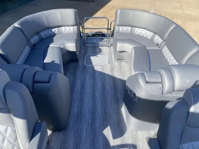 Slide: The Image of 2025 Bennington 25 QFBA pontoon boat with luxurious gray seating and spacious layout. - 25
