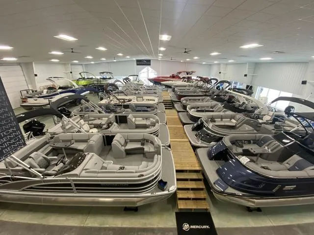 Slide: The Image of Showroom displaying 2025 Bennington 25 QFBA boats, featuring luxurious interiors and sleek designs. - 27