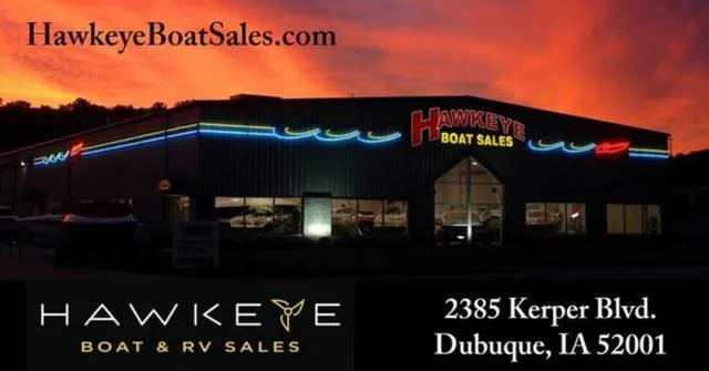 Slide: The Image of Hawkeye Boat Sales dealership at sunset, Dubuque, IA, featuring Bennington 25 QFBA, 2025 model. - 28
