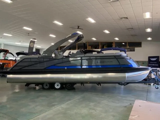 Slide: The Image of 2025 Bennington 25 QFBA pontoon boat displayed indoors. - 3