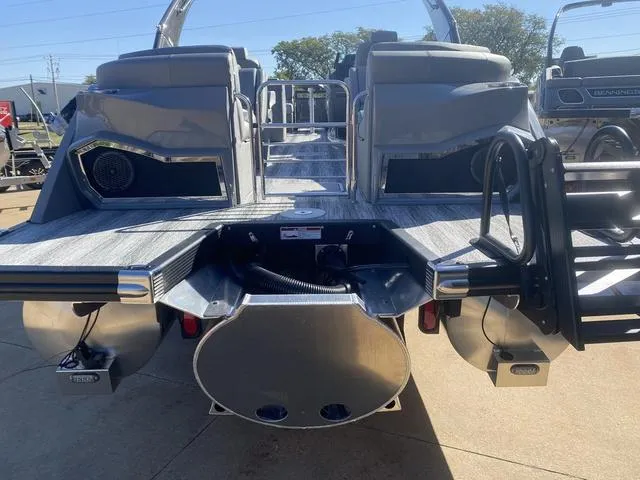 Slide: The Image of 2025 Bennington 25 QFBA pontoon boat rear view with dual engines and seating. - 6