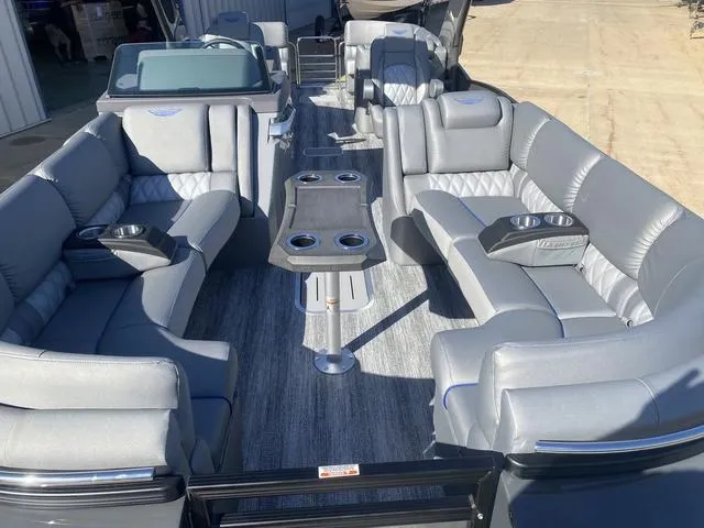 Slide: The Image of 2025 Bennington 25 QFBA pontoon boat with luxurious gray seating and cup holders. - 9