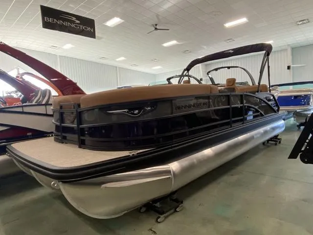 Slide: The Image of 2025 Bennington 24' MSB Tri-Toon boat displayed in showroom. - 1