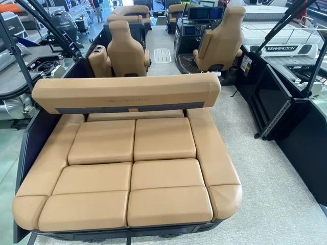 Slide: The Image of 2025 Bennington 24' MSB Tri-Toon boat interior with tan seating and modern dashboard. - 11