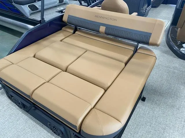 Slide: The Image of 2025 Bennington 24' MSB Tri-Toon with tan cushioned seating. - 13