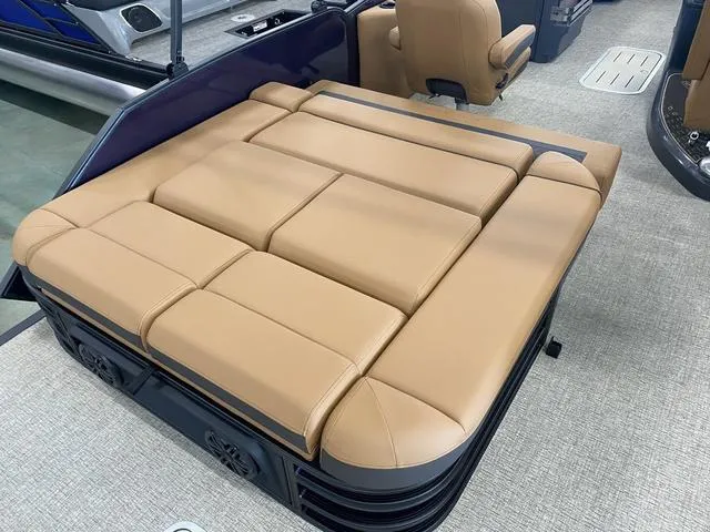 Slide: The Image of 2025 Bennington 24' MSB Tri-Toon with tan cushioned seating and modern design. - 14