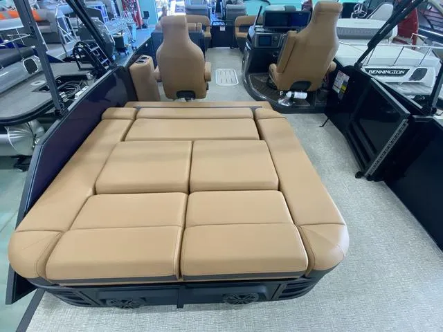 Slide: The Image of 2025 Bennington 24' MSB Tri-Toon with spacious tan seating and modern interior design. - 16