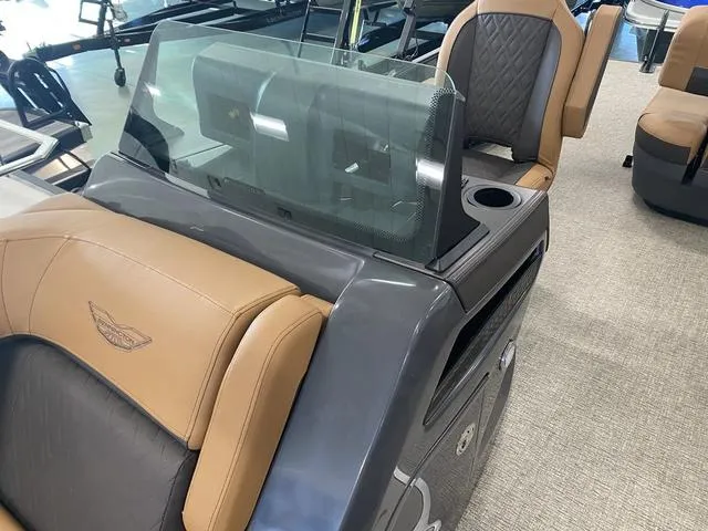 Slide: The Image of 2025 Bennington 24' MSB Tri-Toon boat interior with tan and gray seating. - 17