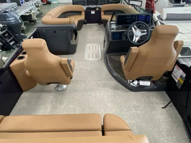 Slide: The Image of Interior of 2025 Bennington 24' MSB Tri-Toon boat with tan seating and modern dashboard. - 18