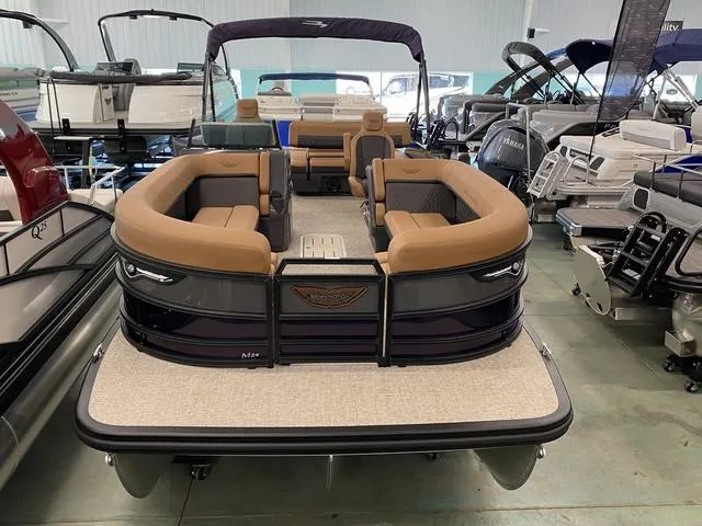 Slide: The Image of 2025 Bennington 24' MSB Tri-Toon boat with luxurious seating in showroom. - 2