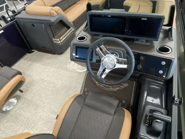 Slide: The Image of 2025 Bennington 24' MSB Tri-Toon boat interior with modern steering console and seating. - 23