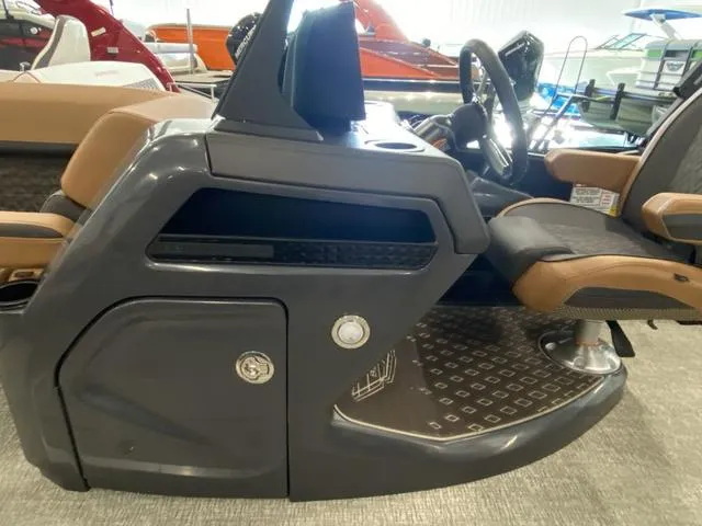 Slide: The Image of 2025 Bennington 24' MSB Tri-Toon helm with modern controls and seating. - 24