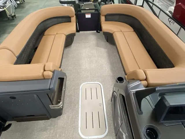 Slide: The Image of 2025 Bennington 24' MSB Tri-Toon interior with tan seating and spacious layout. - 27
