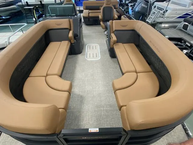 Slide: The Image of 2025 Bennington 24' MSB Tri-Toon with spacious tan seating and modern design. - 28