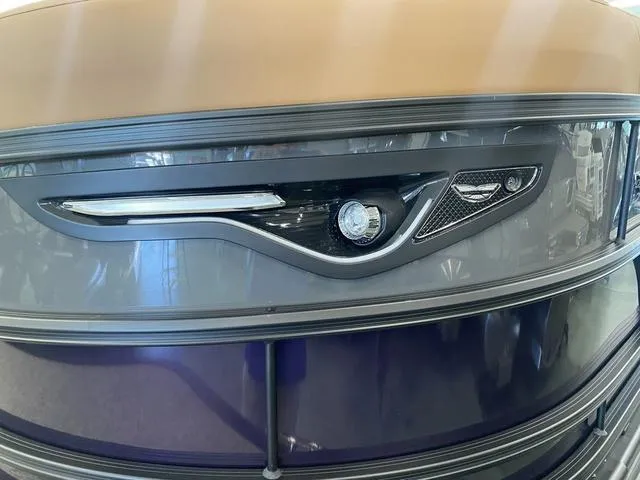 Slide: The Image of 2025 Bennington 24' MSB Tri-Toon boat front detail with sleek design and modern lighting. - 5