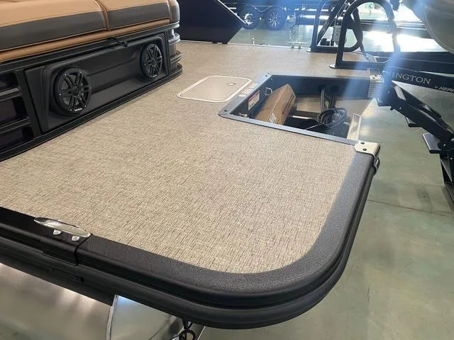 Slide: The Image of 2025 Bennington 24' MSB Tri-Toon boat deck with storage compartment and speakers. - 7